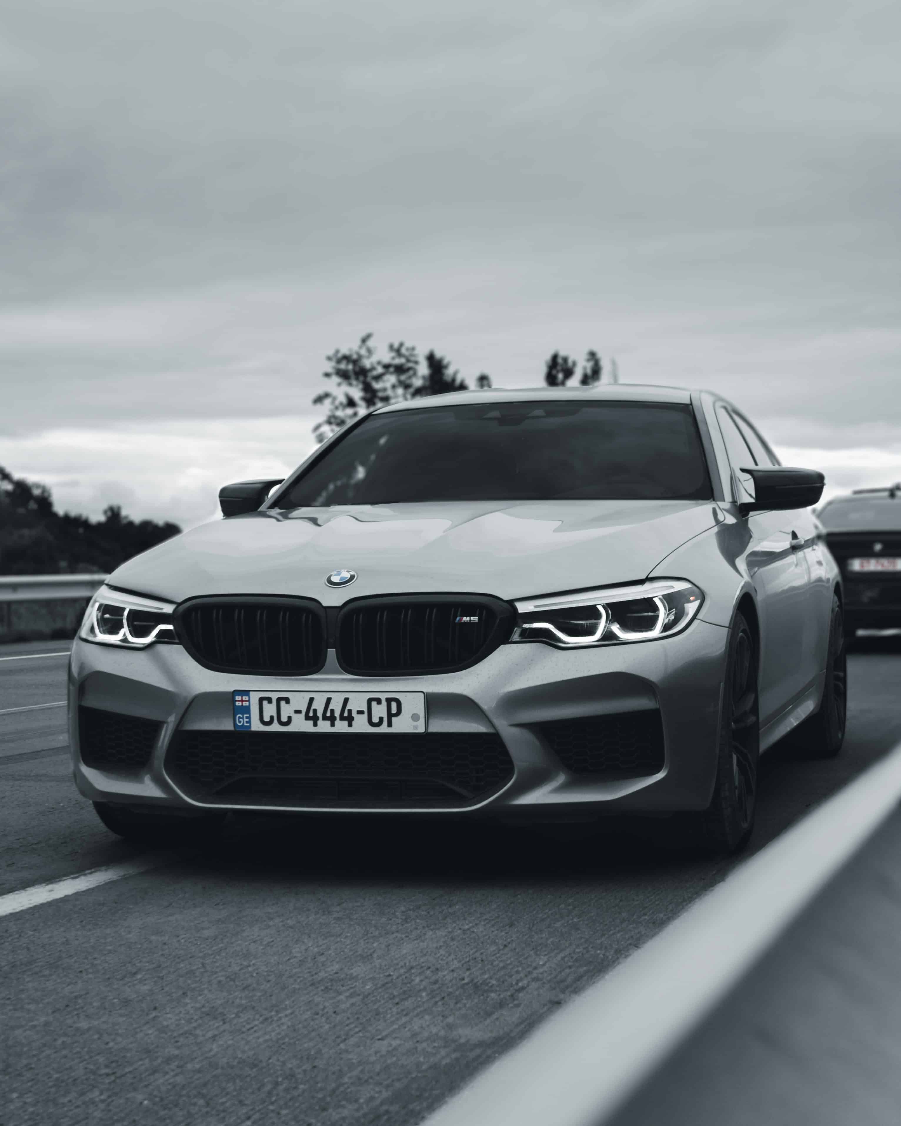 2026 BMW M5 Competition front three-quarter – iconic kidney grille, aggressive aero, quad exhausts